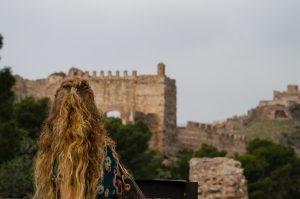 tourist looking at sagunto's ancient ruins